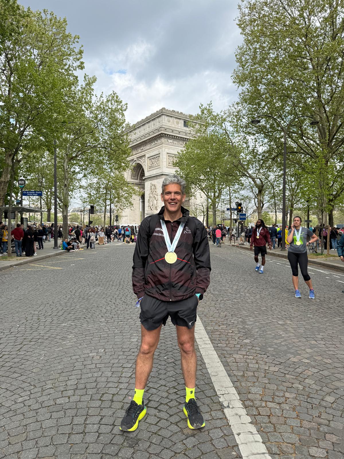 Gabriele wearing his Cheltenham Running Club jacket and marathon medal in Paris